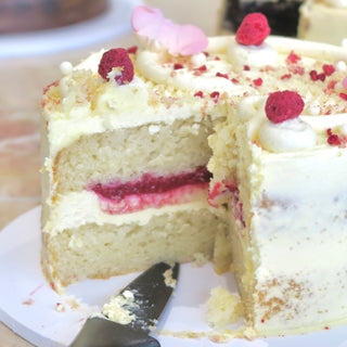 White chocolate raspberry cake cut